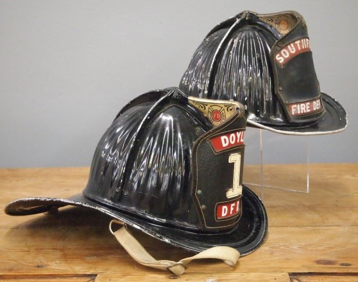 Two  Vintage Carins & Brother Metal Fire Helmets.  Marked "Doyle DFD" and a "Southfield Fire Department".  Some wear, losses to paint the Southfield helmet is lacking a liner.  Up to 14" long.    