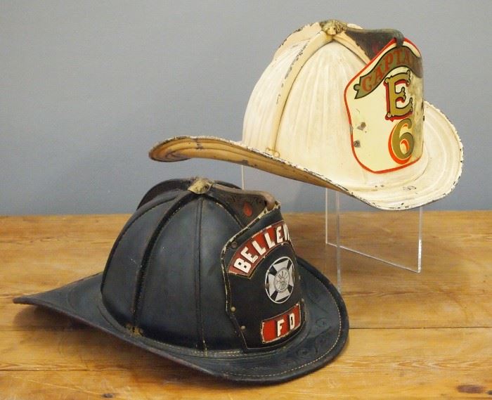 Two Vintage Cairns & Brother Fire Helmets.  Including one molded leather "Belleville FD" helmet and 1 metal "Captain EF" helmet.  Some wear, losses to paint.  Up to 14" long. 