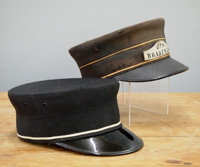 Two Vintage Railroad Hats.  Including one with "GTW Breakman" badge by Marshall Field & Company, Chicago, and one hat with no label by Pettibone Bros. Mfg. Co..  Up to 10" long.  Fabric on each shows some soiling and wear.