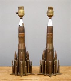 Two Trench Art Lamps.  Comprised of mixed artillery and shell casings, with star form bases.   Wear and some denting, lacking shades.  17 1/2" high. 