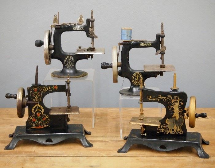 Four Vintage Toy Sewing Machines.  Two by Singer and two Germans models by Casige.  Wear and minor damage.  Up to 7" high. 