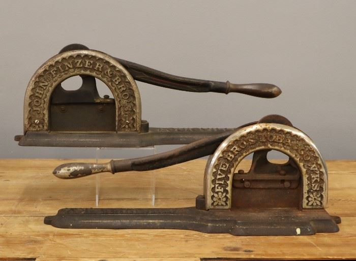 Two turn of the century John Finzer & Bros. Cast Iron Tobacco Cutters.   Wear and some damage.  Each 18" long overall.