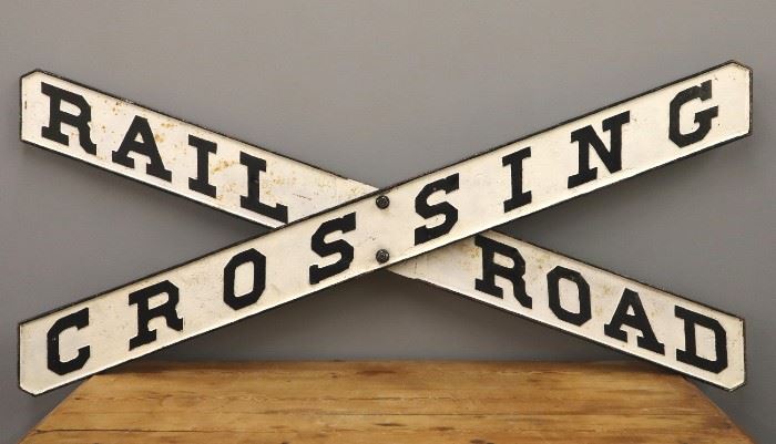 A late 19th century Railroad Crossing Sign.  Cast iron crossbuck repainted black and white.  Minor paint loss, corrosion.   66 1/4" wide 29 3/4" high. 