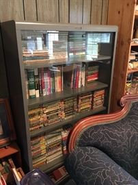 Vintage metal HON office cabinet with shelves and sliding glass doors.