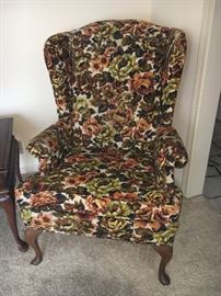 Vintage green and brown wing back chair.