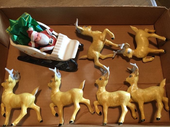 Ceramic sleigh and 6 reindeer.