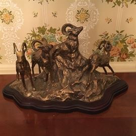 Brass sculpture on wooden base.