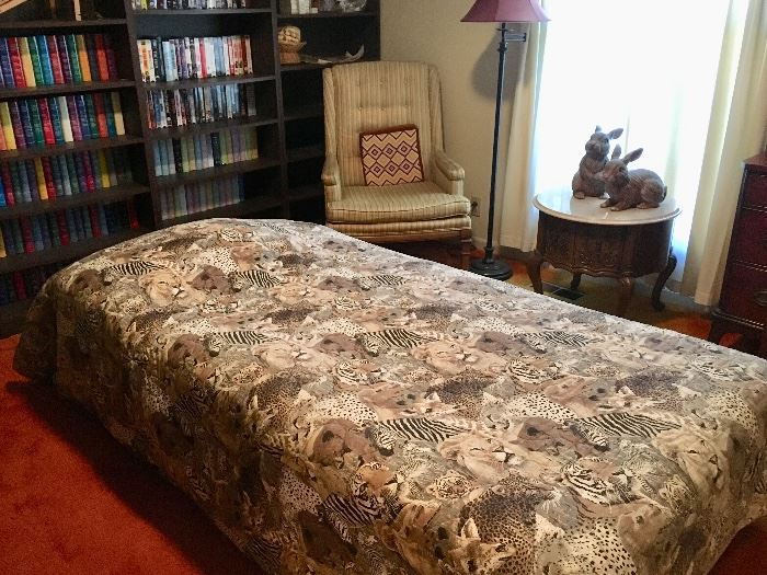 Twin bed, bookcases, books, vintage chair and more.
