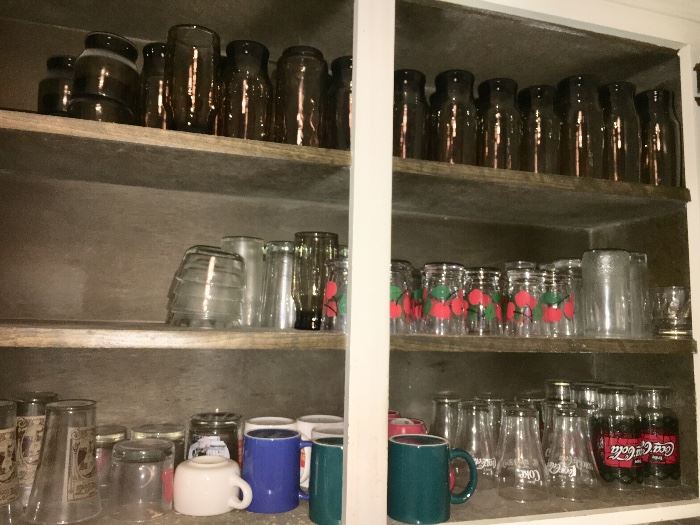Assorted kitchenware—glasses, dishes, pots and pans, small appliances, stainless steel flatware and more.