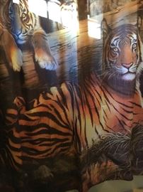 Tiger-theme bathroom linens—shower curtain, rug, towels.