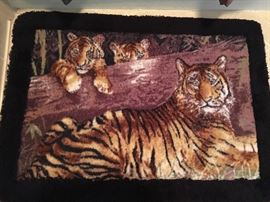 Tiger-theme bathroom linens—shower curtain, rug, towels. 