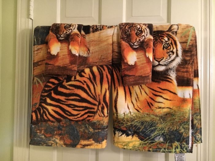 Tiger-theme bathroom linens—shower curtain, rug, towels.