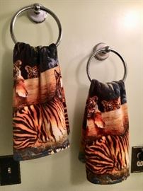 Tiger-theme bathroom linens—shower curtain, rug, towels.