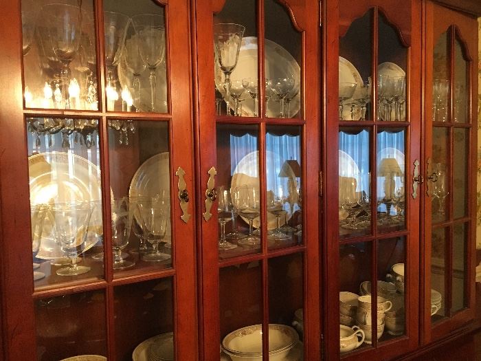 Beautiful cherry china cabinet filled with Homer Laughlin china and stemware.