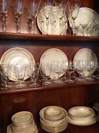 Beautiful cherry china cabinet filled with Homer Laughlin china and stemware.