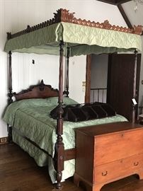 GEORGE III STYLE CARVED MAHOGANY FOUR-POSTER TESTER BED                                                                          19th Century                                                                                             The serpentine arched headboard centering a floral spray within reeded and Gothic paneled leaf-carved posts, the tester with pierced gadrooning and leafage.