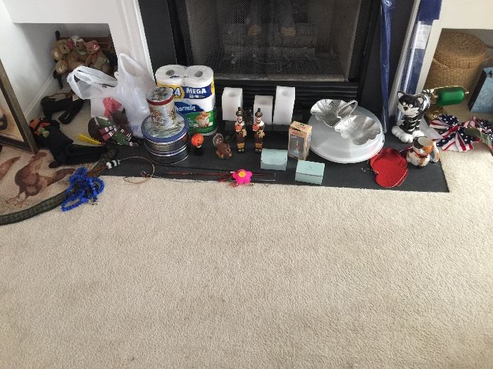 
plastic holder, metal dish, thanksgiving items, candles, half circle rug, cat leash, little bears on a bench