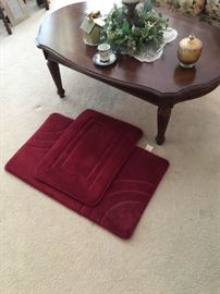 bathroom rugs appear new, coffee table