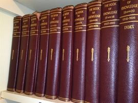 The Book of Knowledge in red and gold enhances any bookshelf.