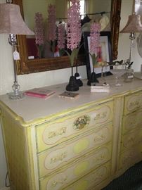 Charming dresser in yellow, green, and pink; pink shaded lamps