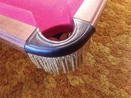 Custom Oak Pool Table by Golden West Billiards with accessories - the rectangular top having a plaque reading "Custom Made by Golden West Billiards, Inc. Los Angeles, CA", surrounding a red or maroon felt playing surface, the rail with leather and scarlet bullion fringe pockets, above shaped paneled sides, the whole rising on cabriole legs, ending in scroll feet. 32" high X 109" wide X 59" deep together with 1 cover, set of balls, cue sticks, racks & cue ball, 