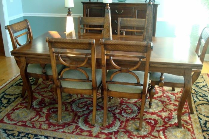 Arhaus dining table with hidden extension leaves and six chairs.  Also dining room wool rug.