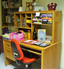 DESK IN THE REC ROOM WITH PULL OUT COMPUTER TRAY AND VERY USEABLE TOP SPACE  AND RED DESK CHAIR