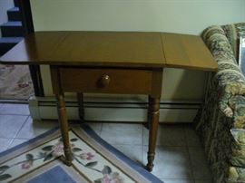 DOUBLE DROP LEAF TABLE WITH DRAWER IN THE REC ROOM NEXT TO LOVESEAT 