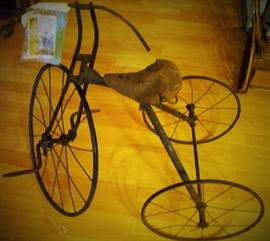 THE SPECIAL ITEM OF THE SALE.  TURN OF THE CENTURY METAL BIKE WITH WELL USED LEATHER SEAT.  HAS A PICTURE OF LITTLE BOY RIDING THE BIKE.  ALSO WE HAD THE PIC ENLARGED AND FRAMED TO GO WITH THE BIKE.  IT'S AT THE CHECK OUT TABLE SO WHEN YOU BUY THIS BE SURE TO TAKE THE BIGGER PHOTO ALS 