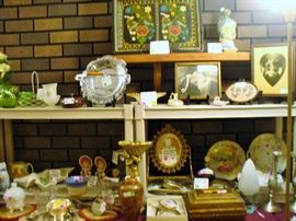 PARTIAL VIEW OF MISC FOLKART, GLASSWARE, VANITY MIRROR AND OLD GLADIATOR DECANTUR, CHROME SERVER WITH BAKELITE HANDLE