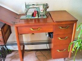 NEW HOME SEWING MACHINE IN CABINET. 