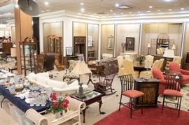 The end table closest to the red geraniums is a display table - with drawer opening up.