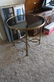 Contemporary polished brass table, with a solid marble top.  Takes 2 people to move it!