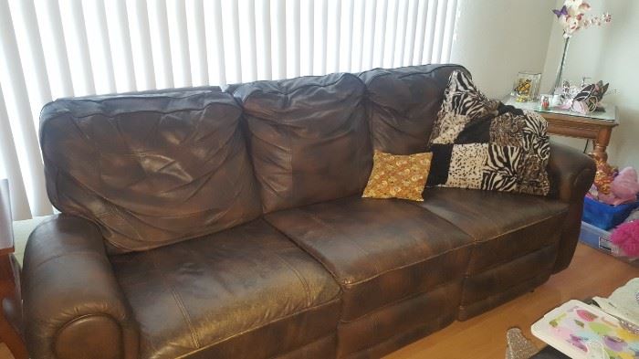 Brown Leather Couch with Recliners on each end. Electric