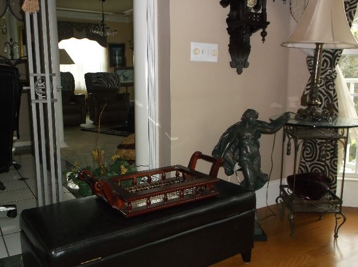 Faux leather upholstered trunk, lady statue, and metal glass top table