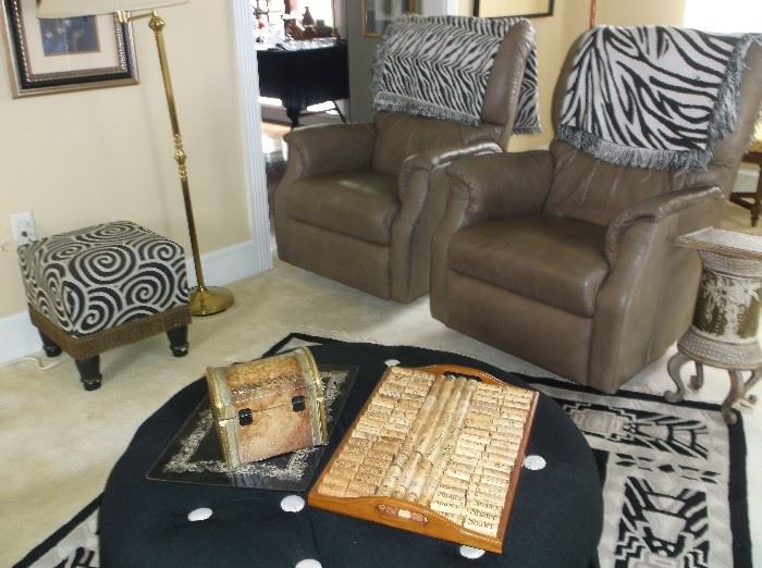 Pair of taupe leather recliners and large round ottoman
