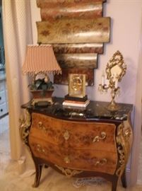 Black marble top bombay chest, metal palm lamp, and lighted table top mirror 