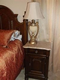One of two marble top bedside tables and lamps