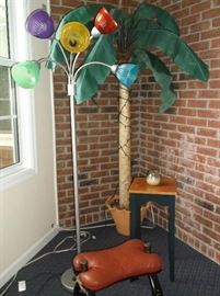 Palm tree, goose neck floor lamp,  saddle foot stool, and small painted side table