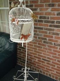 Large vintage wrought iron bird cage on stand