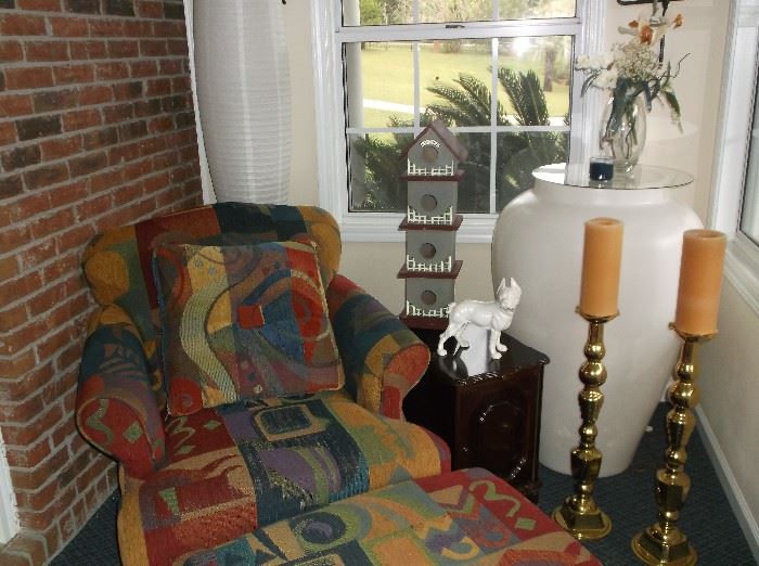 Multi-colored upholstered chair w/ottoman, pair of tall brass candlesticks,  and huge lighted urn table