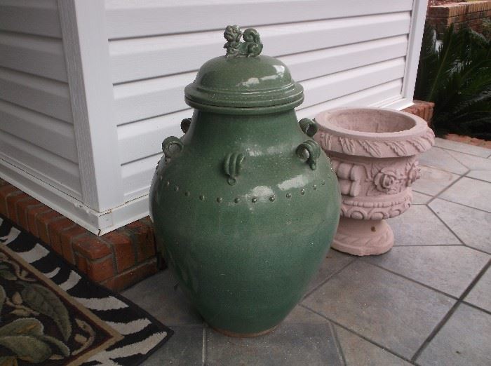 One of a pair of large green pottery jars