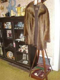 Fur coat bent wood coat rack, set of silverware.