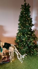 lighted tree and grazing reindeer