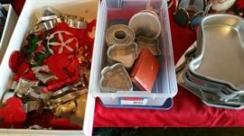stacks of cookie cutters and molds for cakes and tarts - all holiday themed