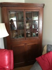 Beautiful Country corner cupboard with original wavy glass, shelves, etc. Perfect collectors piece.