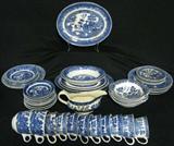 Lot #200:  54 Older Pieces Blue Willow, Marked Japan, Homer Laughlin and Various English. Lot Inc. 6 Luncheon Plates (1 Chipped, 1 w/Minor Age Cracks), 4 Oval Platters (9.5-12"L, 1 Chipped, 1 w/Age Cracks), 2 Oval Vegetable Bowls, 6 Lug Bowls (All w/Chips), 12 Saucers (4 Damaged), 11 Cups (2 Chipped), 4 Bread Plates and Gravy Boat (Chipped).
