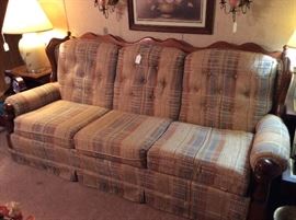 Sofa with wooden back.