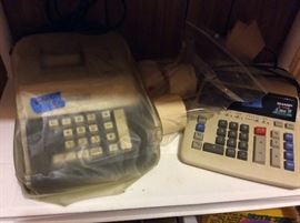 vintage adding machine and newer one.