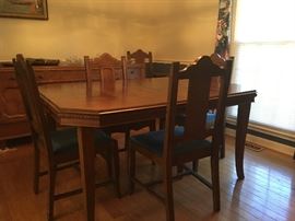 Solid walnut dining table and six chairs, has two leaves for table. Manufactured in Evansville, IN by Klamer Furniture 